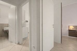 A modern bathroom with a white sink and a mirror. - Viola Apartment - Lake View Two-Room with WiFi, Air Conditioning, and Lake View (Sirmione)