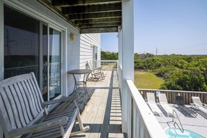 A wooden deck with a pool, outdoor furniture, and a view of the surrounding landscape. - 2 min Walk to Beach w Ocean Views, Pool, Game Room (Nags Head)