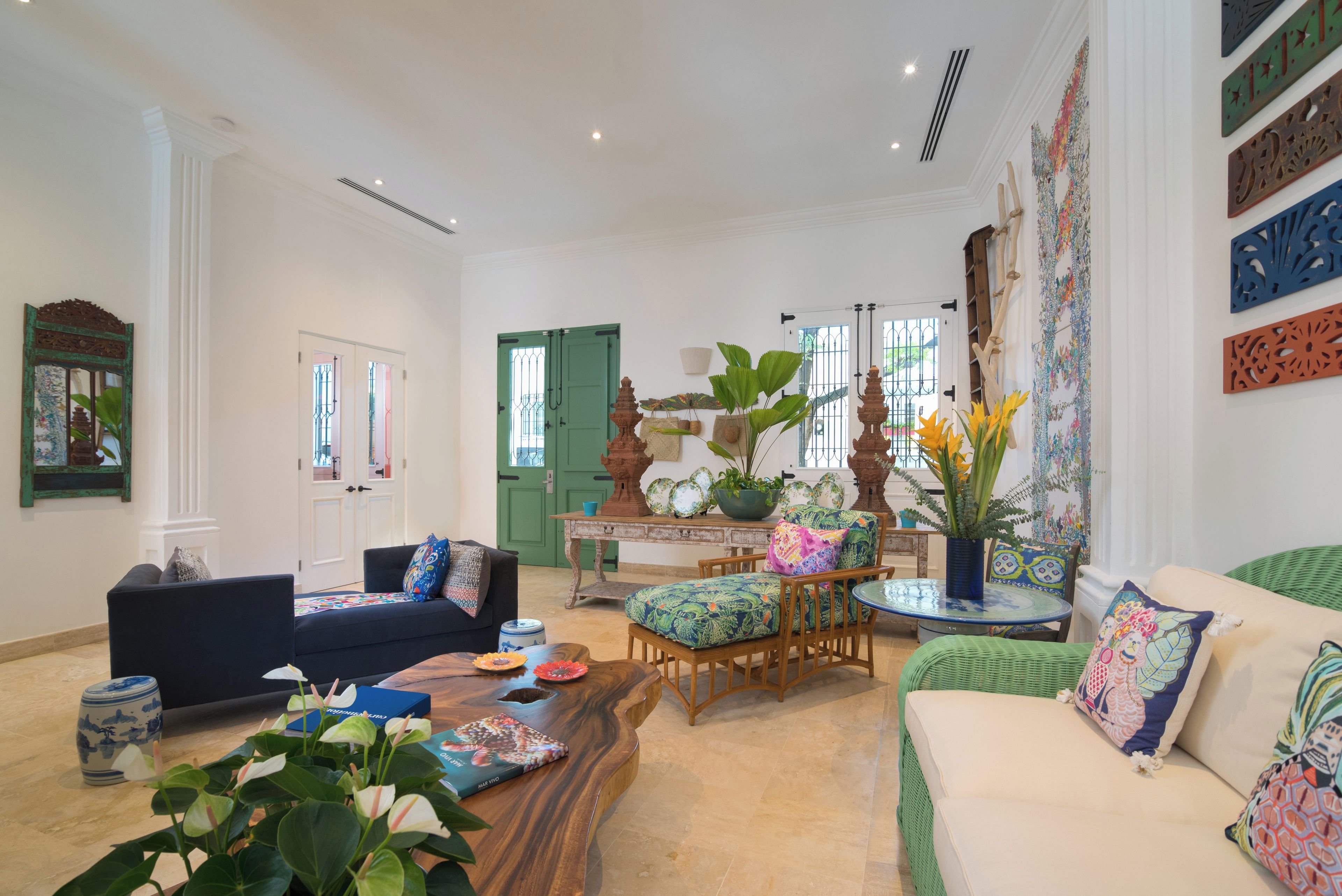 A spacious living room with a sofa, armchair, and coffee table.