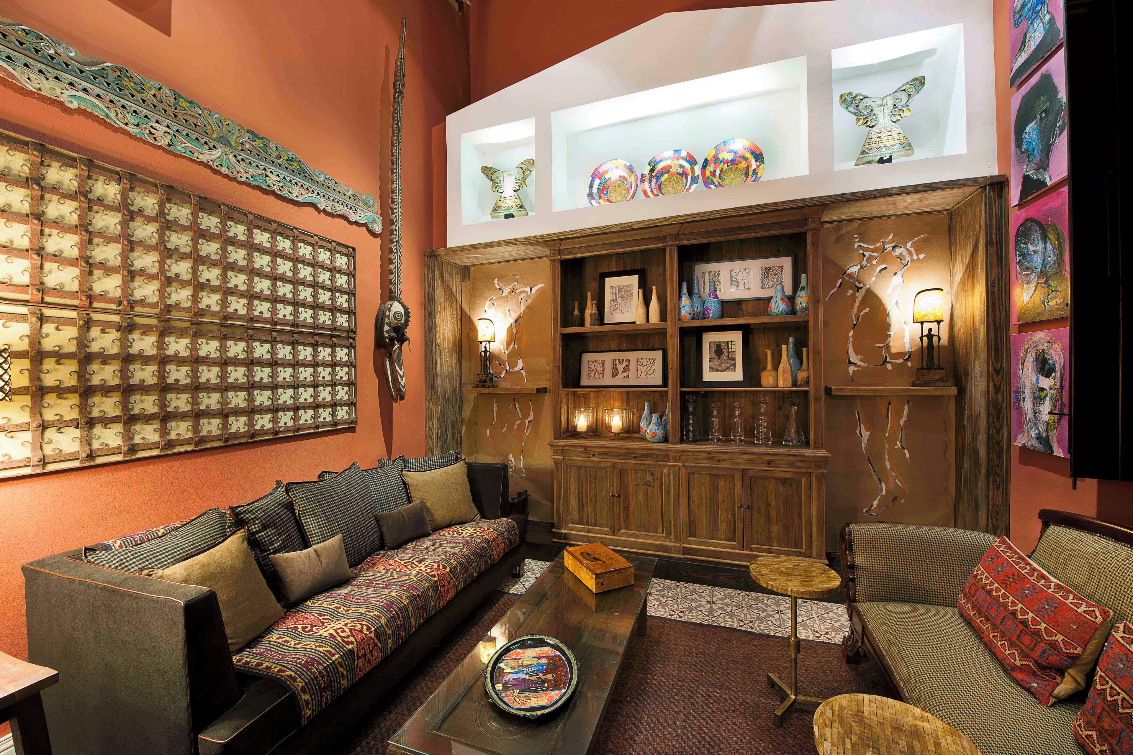 A cozy living room with a sofa, a coffee table, and a bookshelf.