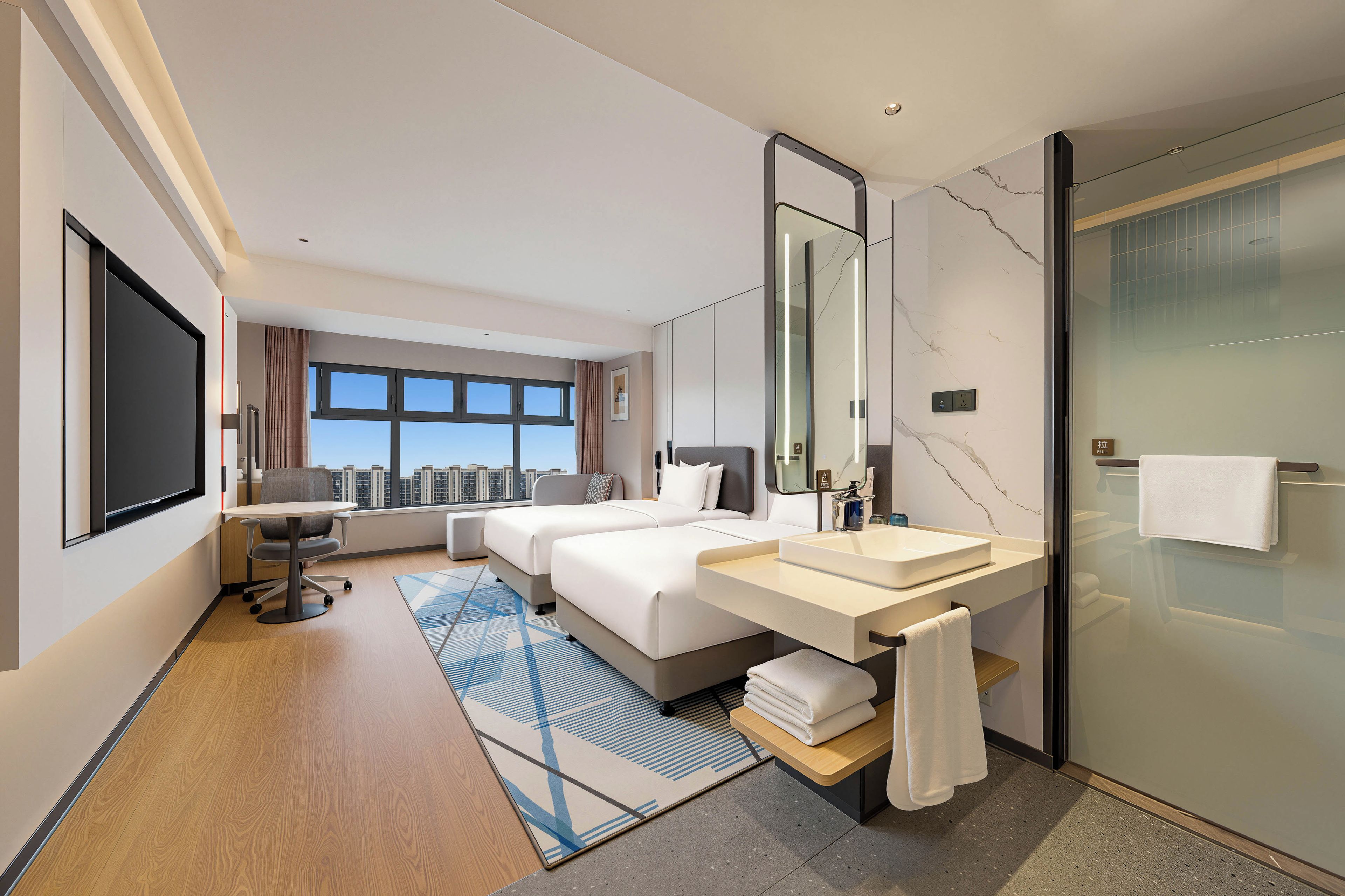 A modern hotel room with a large bed, a desk, a bathroom with a glass shower, and a view of the cityscape.