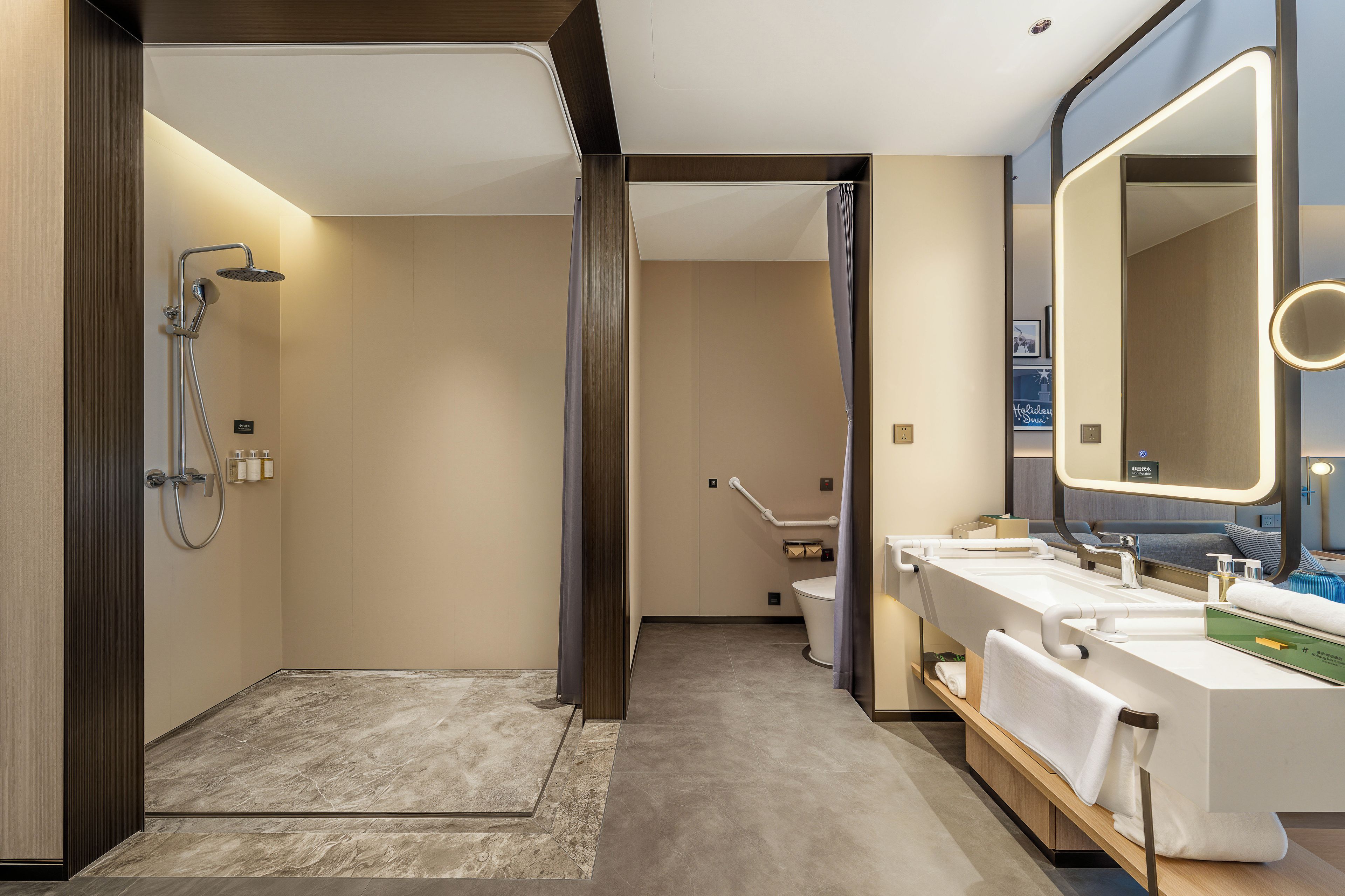 A modern bathroom with a shower, toilet, and sink area.