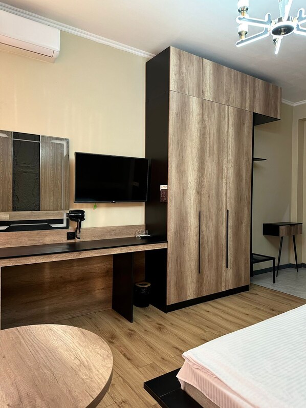 A modern bedroom with a bed, a desk, and a wardrobe. - VanParkHotel (Shymkent)
