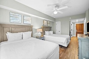 A hotel room with two beds, a ceiling fan, and a wooden headboard. - Alluring Studio Property In The Center Of Sandestin's Baytowne Wharf (Miramar Beach)
