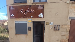 A building with a sign reading 'Azafran' and 'La Carrasca.' - Azafrán Apartment (Blancas)