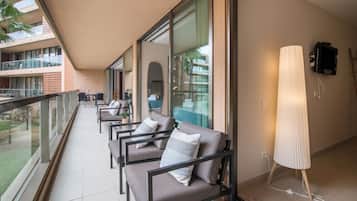 A balcony with seating and a television.