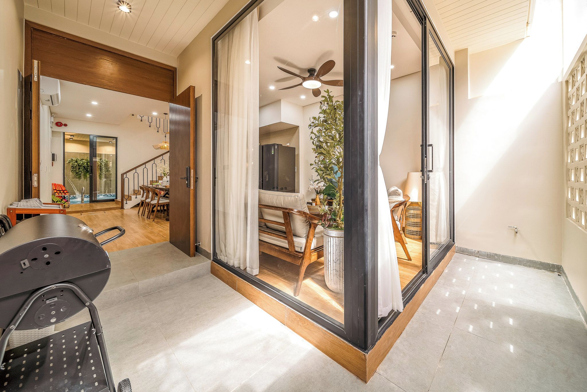 A modern interior with a dining area, a kitchen, and a living space.