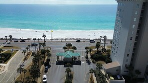 A coastal hotel with a view of the beach, a parking lot, and a road with vehicles. - Coucher du Soleil at Seascape, 3 bedroom Condo Miramar Beach Florida (Miramar Beach)