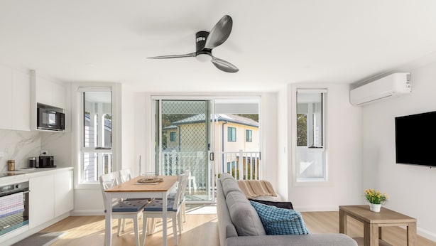 Een modern appartement met keuken, eethoek en woonkamer.