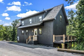 A two-story wooden cabin with a porch and a deck. - Relaxing 2BR Retreat Near Douglass Lake (Sevierville)