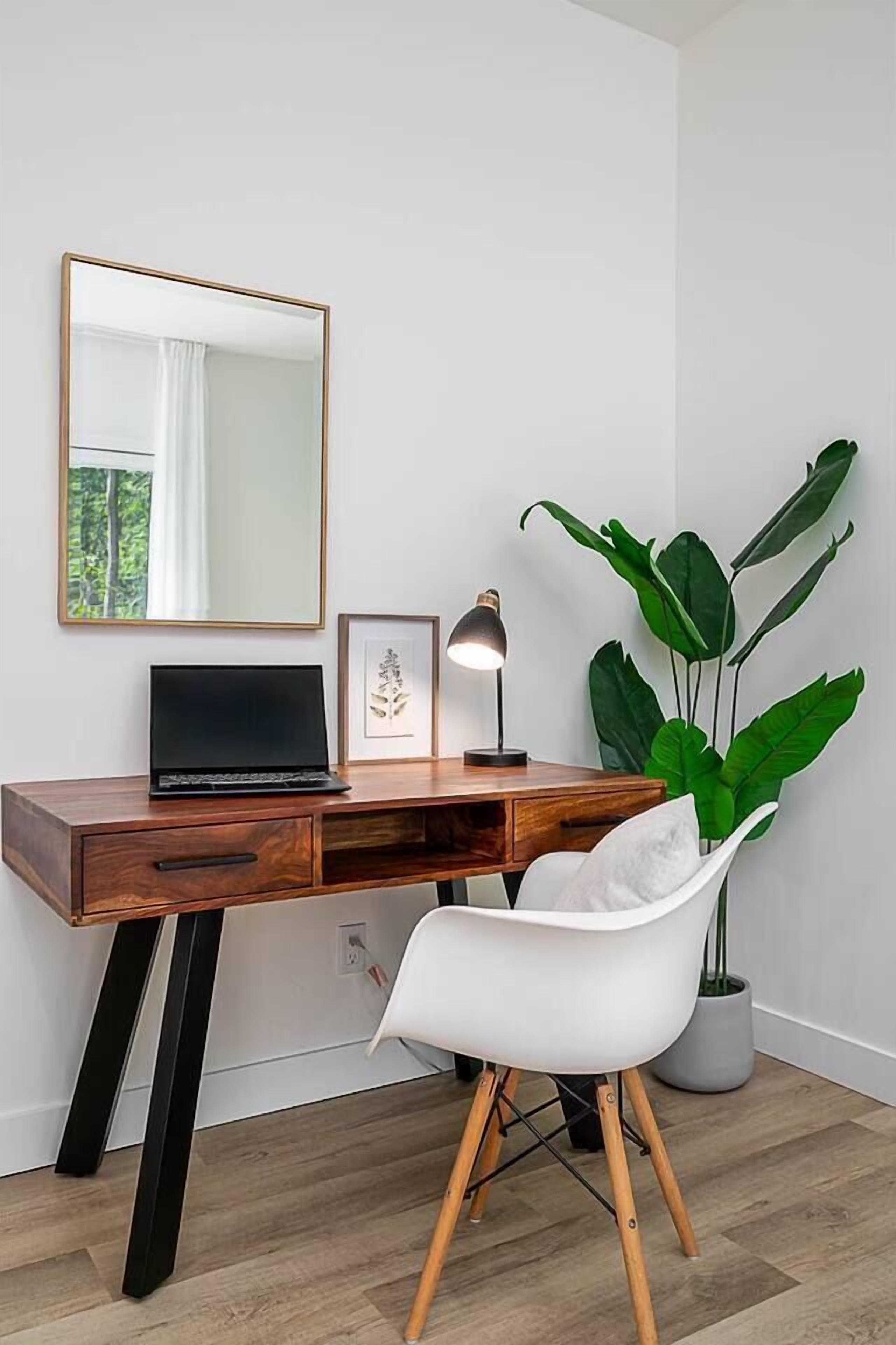Bright modern workspace with stylish desk, lamp, and cozy designer chair