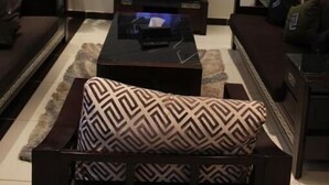 Un salon avec un téléviseur, un canapé et une table basse.