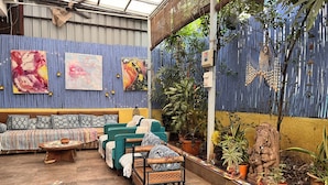 An outdoor seating area with a sofa, chairs, and a small table.