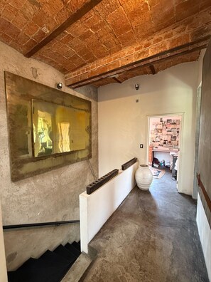 A staircase with a glass panel and a white wall with a framed collage. - Zacatecas 167, Industrial charm and vintage style in the heart of Roma Norte (Ciudad de México)