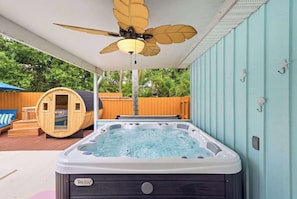 A hot tub with a ceiling fan, wooden deck, and a wooden sauna. - Sauna • Cold Plunge • Sports Court • Pool • Hottub (Bradenton)