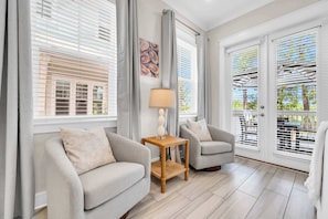 A modern living room with two sofas, a small wooden table, and a lamp. - Gathered by the Sea by Stay on 30a (Inlet Beach)