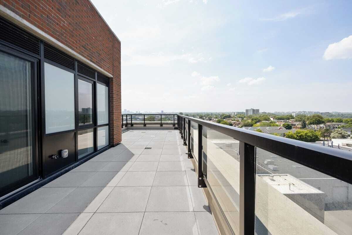 A balcony with a clear view of the cityscape.