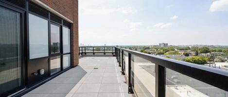 A balcony with a clear view of the cityscape.