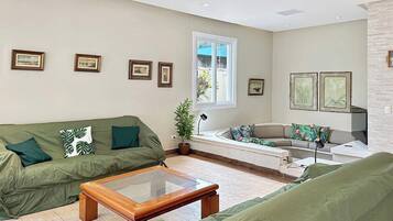 A living room with a sofa, a coffee table, and a window.