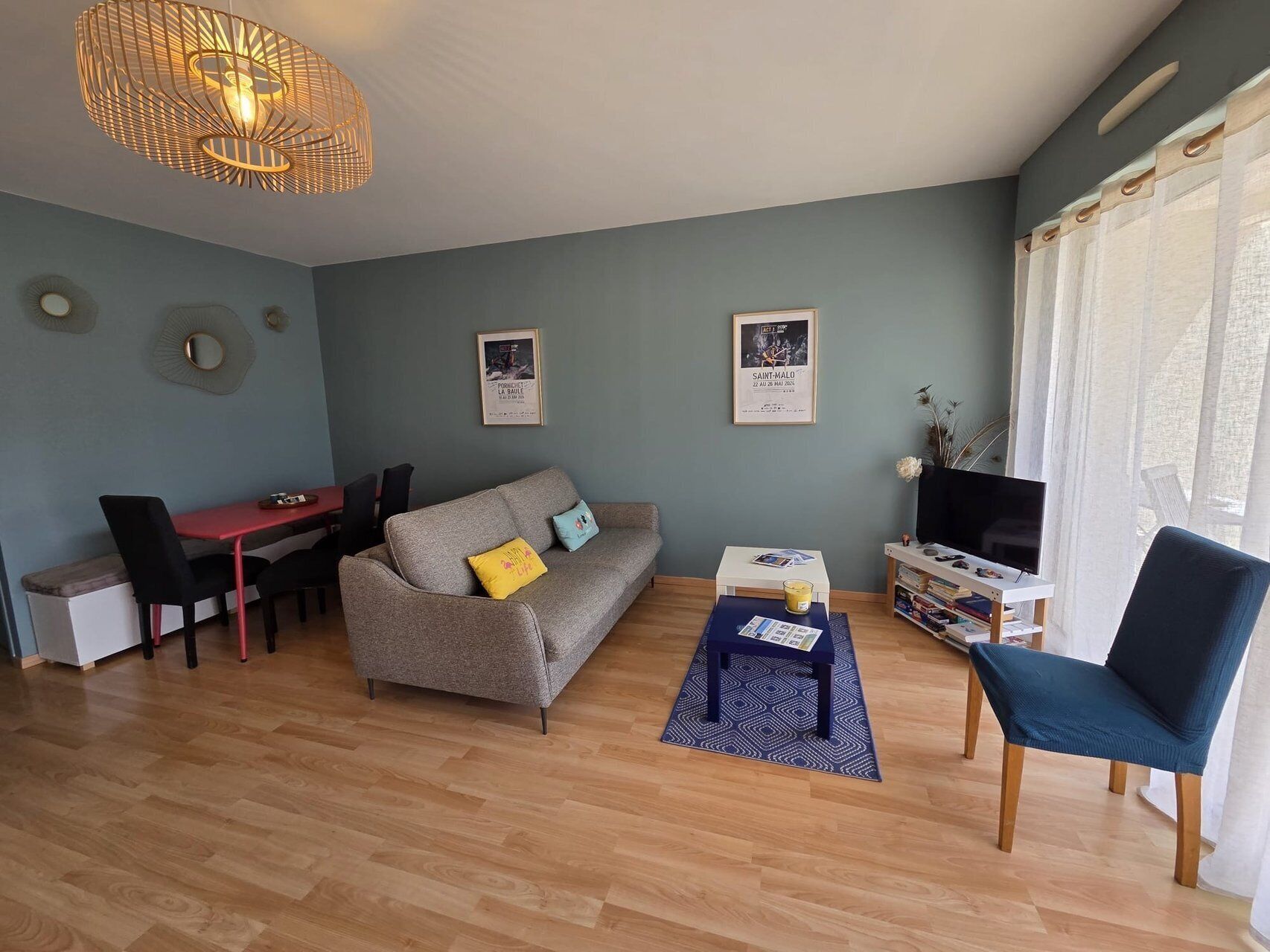 Ein Wohnzimmer mit Sofa, Couchtisch, Fernsehtisch und Essbereich.