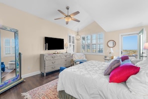 A bedroom with a bed, dresser, TV, and a view of the outdoors. - 4 Bedroom, Walk to Downtown St Augustine Luxury (St. Augustine)