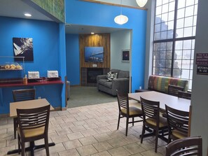 A room with a dining area, a kitchenette, and a seating area with a view. - Private Whirlpool Stay Near Lake Huron for a Relaxing Tawas City Escape (Tawas City)