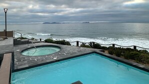 A swimming pool with a view of the ocean and a cloudy sky. - Vrbo Property (Tijuana)