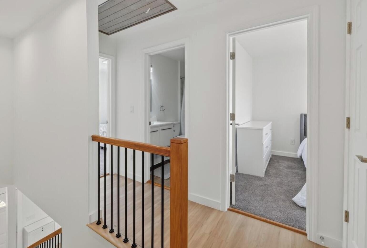 A multi-level interior with a staircase, a bathroom, and a bedroom.