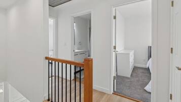 A multi-level interior with a staircase, a bathroom, and a bedroom.
