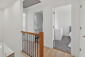 A multi-level interior with a staircase, a bathroom, and a bedroom. - New 3bdrHome • 2 Min to Downtown.2.5 bathroom (Spartanburg)