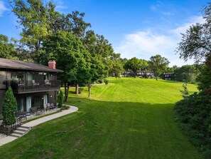 A residential area with a house featuring a balcony, a well-maintained lawn, and a clear sky. - Luxury Lake Geneva 2BR/2BA retreat fully renovated sleeps up to 6 near lake Como (Lake Geneva)