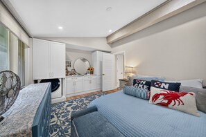 A bedroom with a bed, a dresser, a mirror, and a fan. - Luxury Lake Geneva 2BR/2BA retreat fully renovated sleeps up to 6 near lake Como (Lake Geneva)