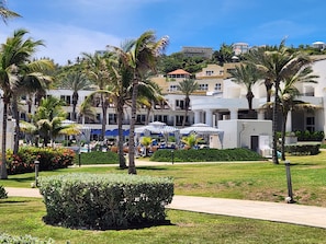 A resort with multiple-story buildings, palm trees, and outdoor seating areas with umbrellas. - Spacious Dawn Beach 3-bedroom condo in delightful Upper Prince's Quarter (Upper Prince's Quarter)