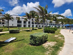 A resort with modern buildings, palm trees, and a clear sky. - Spacious Dawn Beach 3-bedroom condo in delightful Upper Prince's Quarter (Upper Prince's Quarter)