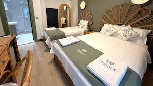 A hotel room with two beds, a wooden headboard, a mirror, a clock, and a small table. - Alâ Marmara Hotel (Marmara)
