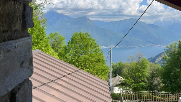 A view from a building's interior looking out to a mountainous landscape with a clear sky.