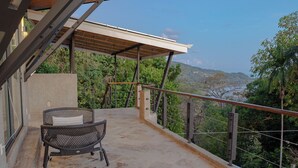 An outdoor balcony with a view of a mountainous landscape, a covered seating area, and a railing. - Vivara: Private House, PH & 5 Villas 180° Ocean View, Dominical CR-16 guest (Savegre de Aguirre, Puntarenas Province)