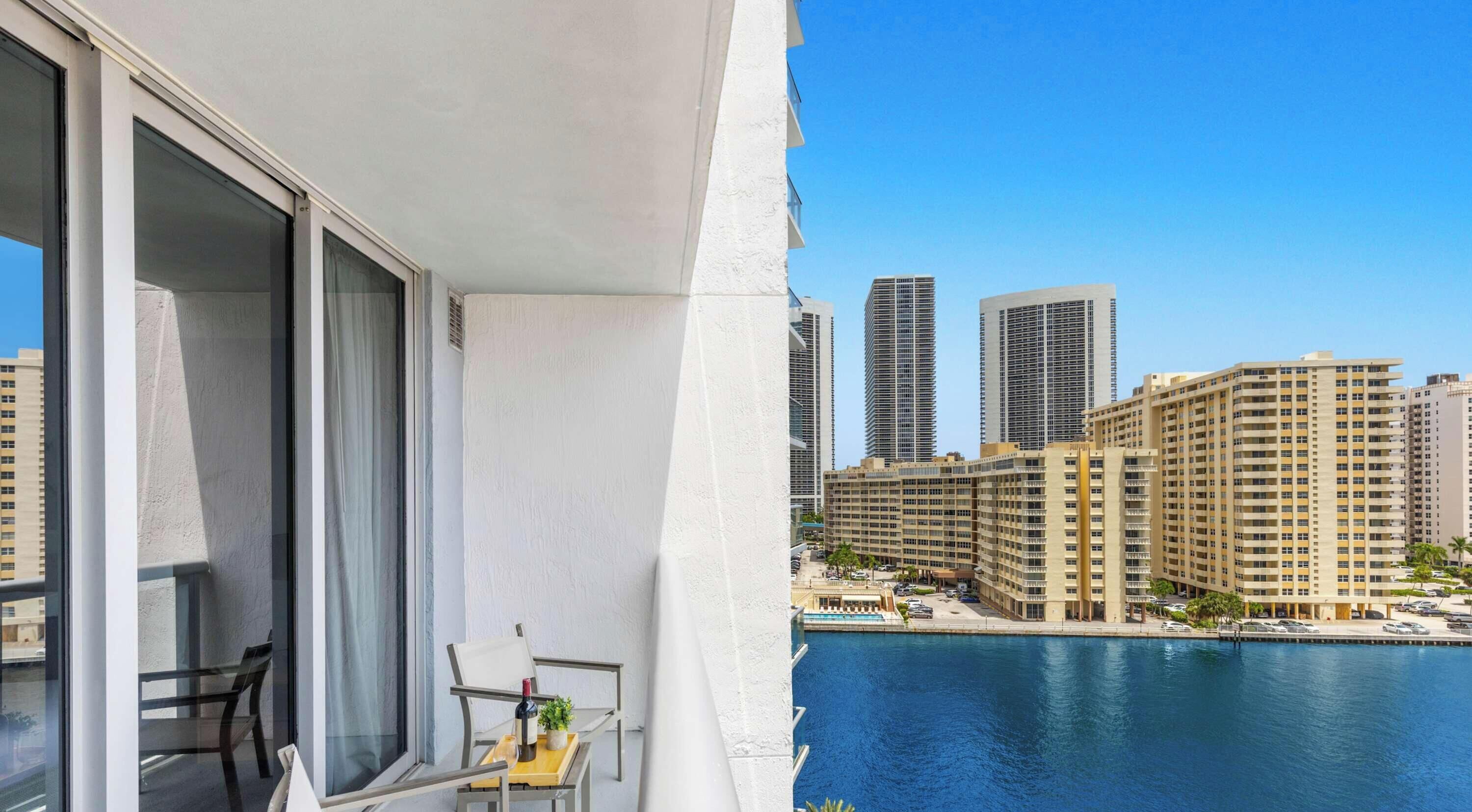 A balcony with a view of a cityscape and a body of water.