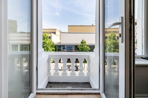 A balcony with a white balustrade and a view of buildings and trees. - Elegant Bayswater Two-Bed near Hyde Park (London)