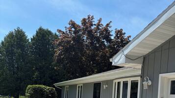 A residential house with a garage, a driveway, and a well-maintained lawn.