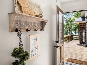 A wooden door leading to a deck with a view of a lake. - Lakefront Beach Retreat w/ Kayaks & Fire Pit! (Sabine Parish)