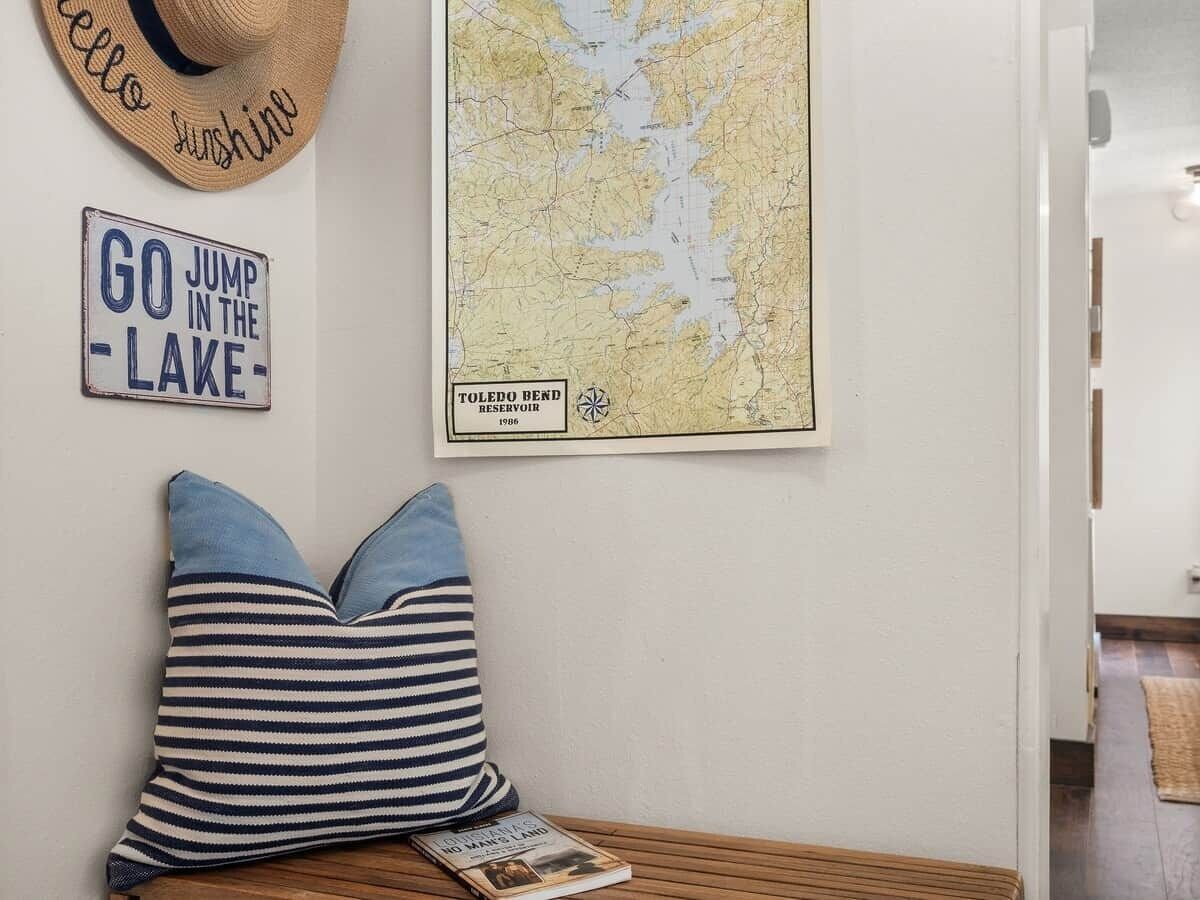 A wall with a map, a sign, and a hat.