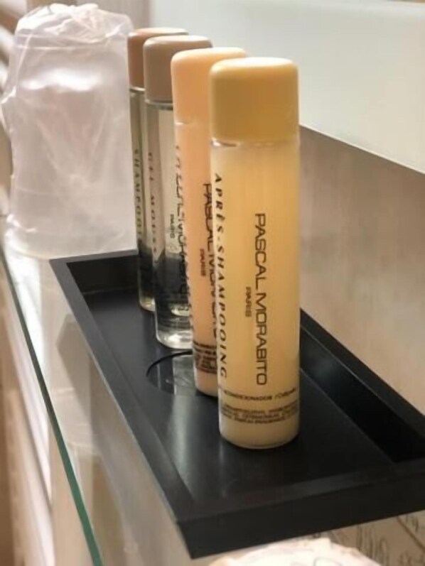A row of hair care products on a black tray.