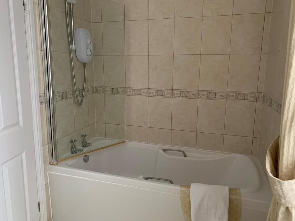 A bathroom with a bathtub, a shower, and a toilet.