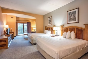 A hotel room with two beds, a desk, a chair, and a balcony. - Spacious 3-bedroom condo @ Chula Vista Resort in superb Wisconsin Dells (Wisconsin Dells)