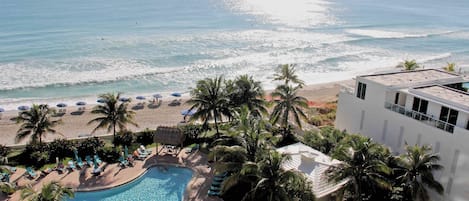 A resort with a pool, beach, and ocean view.