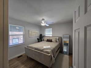 A bedroom with a bed, a ceiling fan, and a window with blinds. - Modern 2BR Retreat Near Downtown Birmingham (Birmingham)