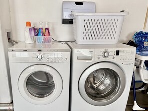 Twee voorladers van LG/TROMM met een witte wasmand erboven.