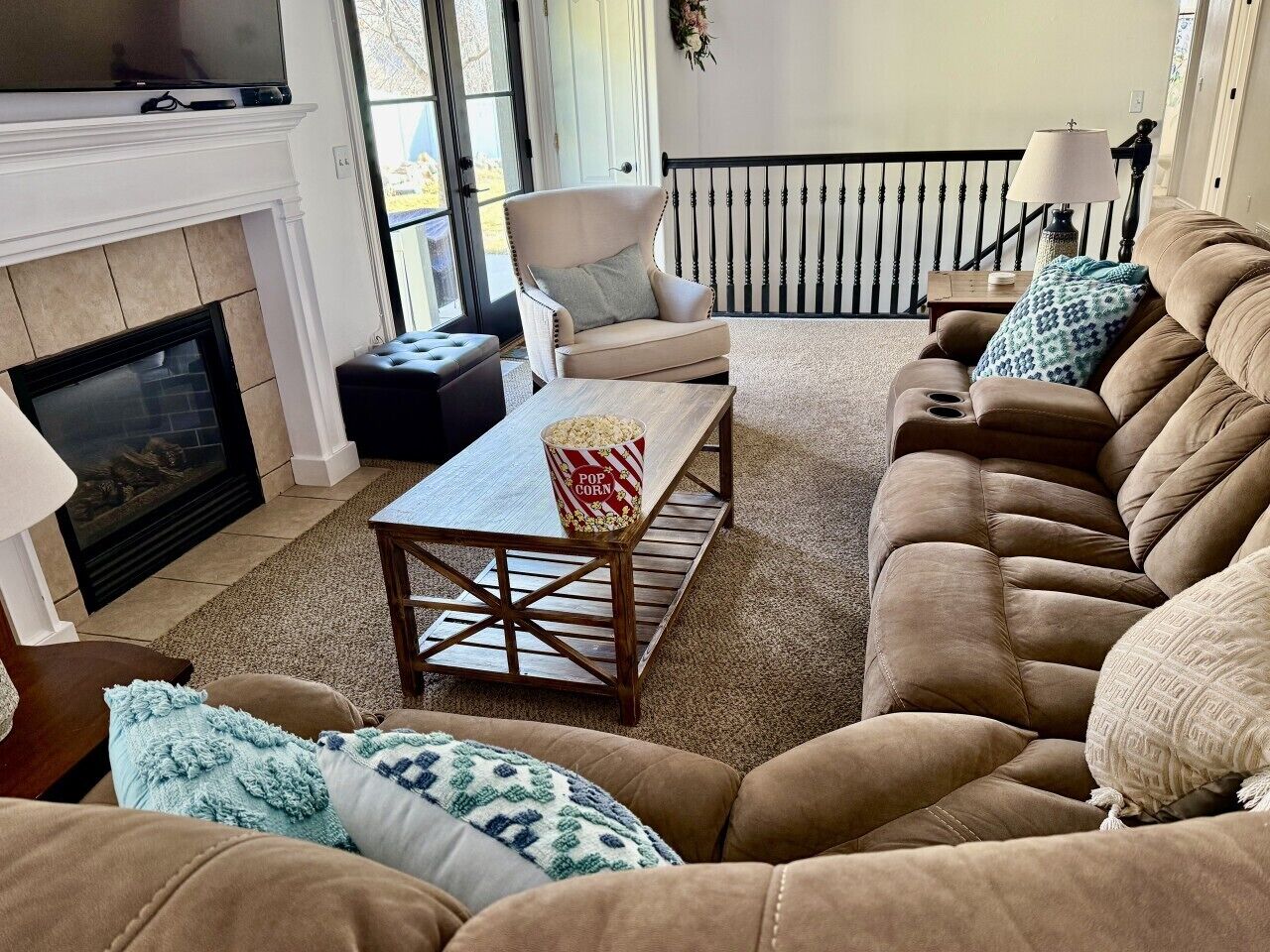 A living room with a fireplace, a sofa, a coffee table, and a television.