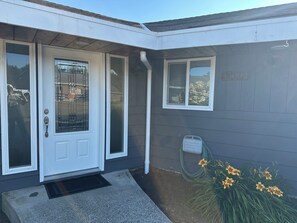 A residential building with a white door, a small window, and a number plaque. - 3 Bedroom Farmhouse with great central location in the PNW! (Snohomish)